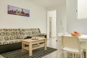 a living room with a couch and a table at 1a Van Halen in Vecindario