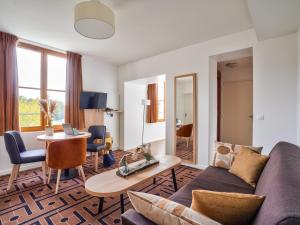 a living room with a couch and a table at Residhome Paris Saclay " Bures sur Yvette " in Bures-sur-Yvette