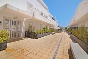 an empty courtyard of a building with plants at Formosa Bay 144 in Cabanas de Tavira