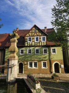 a house with a water fountain in front of it at Panoramablick in Langenburg