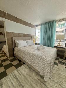 a bedroom with a large bed and a window at Isla Verde Serenity by the Sea in San Juan
