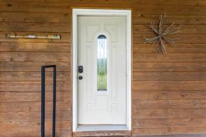a white door on the side of a wooden house at Heavenly Hideaway - near Red River Gorge KY in Beattyville +35 photos