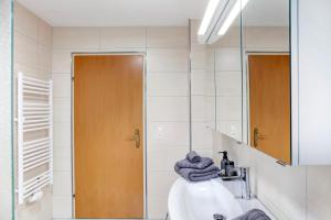 a bathroom with a sink and a mirror at Appartment Stockeben in Niederau +15 photos