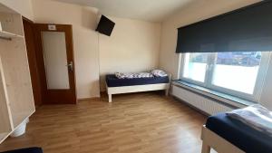 a room with a bed and a large window at Ferienwohnung Löhne in Löhne
