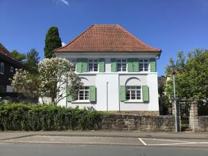 a white and green house with a red roof at Haus vor dem Schöneberger Tor in Hofgeismar