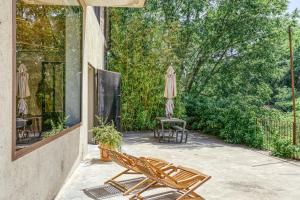 a patio with two chairs and umbrellas on it at Espai Temps - Art Home in Terrades