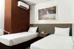 a hotel room with two beds at Madison Suites in Lapu Lapu City +17 photos