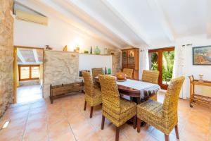 a dining room with a table and chairs at Can Sua in Artá