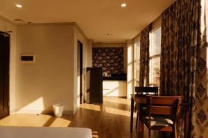 a living room with a table and a kitchen at Madison Suites in Lapu Lapu City