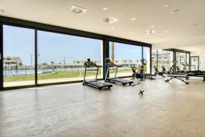a gym with treadmills and ellipticals and large windows at Izabell in Finestrat
