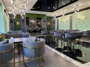 a bar with chairs and tables in a restaurant at Aparan Hotel in Aparan