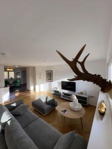a living room with a couch and a table at Auerer Retreat in Frauenau