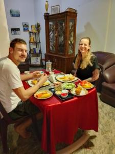 a man and woman sitting at a table with food at Charlotte Inn in Kandy +13 photos