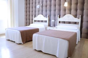 Ένα ή περισσότερα κρεβάτια σε δωμάτιο στο HOSTAL-CAFE GUTGRECO