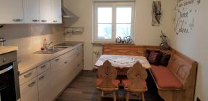 a small kitchen with a table and a sink at Ferienwohnung Breit - Kirchdorf in Kirchdorf im Wald