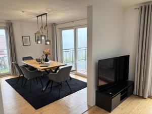 a dining room with a table and a television at Landhaus am Burgberg in Freyung