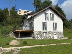 a white house with a balcony on top of a yard at Landhaus am Burgberg in Freyung