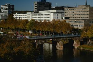 a bridge over a river in a city with buildings at Holiday Inn Express - Saarbrücken by IHG in Saarbrücken
