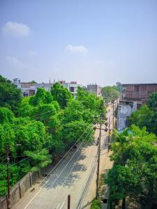 an overhead view of a city street with trees at Hotel Pleasure Inn in Prayagraj +5 photos