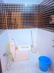 a bathroom with a toilet and a shower at Hotel Pleasure Inn in Prayagraj