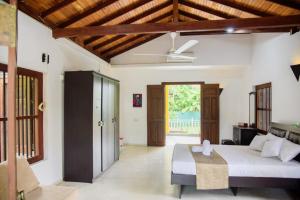 a bedroom with a bed and a ceiling at ABS Villa Bentota in Bentota