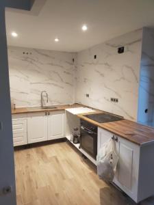 a kitchen with white marble walls and a counter top at HABITACIÓN en chalet cerca Atocha in Madrid