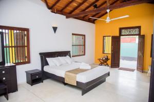 a bedroom with a bed and a tv in it at ABS Villa Bentota in Bentota +6 photos