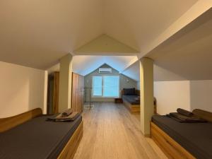 a large room with two beds and a couch at Guest house LORA in Gabrovo