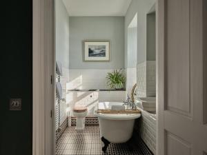 a bathroom with a toilet and a tub and a sink at Luxury House on Private Island, Isle of Skye in Isleornsay +56 photos