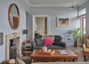 a living room with a couch and a fireplace at Luxury House on Private Island, Isle of Skye in Isleornsay