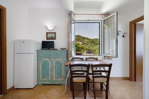 a kitchen with a table and chairs and a window at Agriturismo La Realidad in Finale Ligure