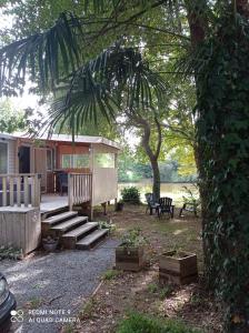 a backyard with a bench and a gazebo at mobil home in Sainte-Reine-de-Bretagne