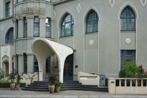 a large building with stairs and an entry way at Roomers Berlin Steinplatz, Autograph Collection in Berlin