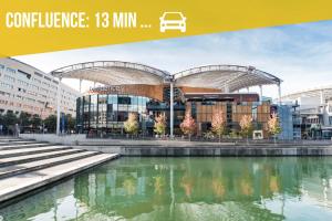 a view of a building with a pool of water at Le Cosy Genin - 3 Chambres Bureaux Parking in Lyon