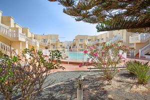 a view of the courtyard of a resort with pink flowers at Marysol in Caleta De Fuste
