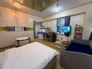 een ziekenhuiskamer met een bed en een keuken bij HOPE RESIDENCES UNIT 606 building D in Trece Martires