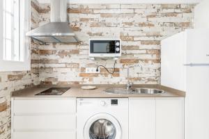 a kitchen with a sink and a washing machine at Apartamento Claudia in Conil de la Frontera +17 photos