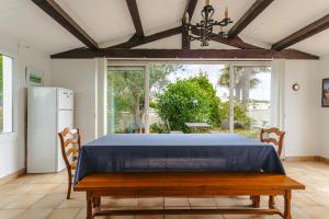 a dining room with a table and a refrigerator at Maison d'hôtes Le Grillon in La Brée-les-Bains