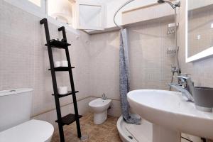 a small bathroom with a toilet and a sink at Apto Pepita - Casa San Marcial in Triana +29 photos