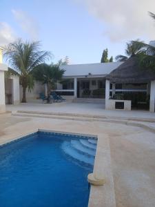 a large swimming pool in front of a house at Chez André Léon in Ngaparou +9 photos