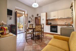 a kitchen and living room with a couch and a table at Casa Michela in Viddalba