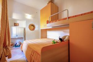 a childs bedroom with a bunk bed with toys on it at Casa Michela in Viddalba