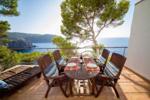 a table and chairs on a balcony with a view of the ocean at Mestral in Port de Soller