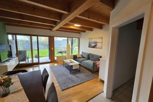 a living room with a couch and a table at Ferienwohnung Casa Karin mit Sauna in Bodman-Ludwigshafen