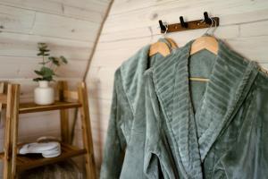 a green jacket hanging on a rack in a room at Coolaness Glamping in Irvinestown