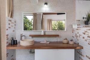 a bathroom with a sink and a mirror at Guenia ll in El Mojón +13 photos