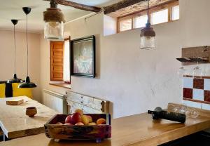 a bowl of fruit on a table in a kitchen at La Manzana in Villafruel