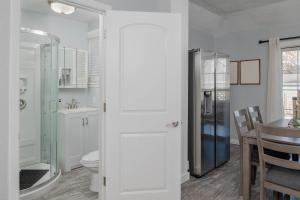a bathroom with a toilet and a sink at Bungalow on Baldwin - 3 bed 2 bath in Oshkosh
