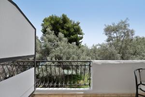 a balcony with a view of trees and bushes at Diamerima 2ari A in Nydri
