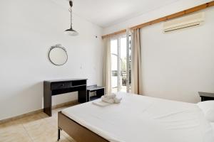 a bedroom with a large white bed and a desk at Diamerima 2ari A in Nydri +12 photos